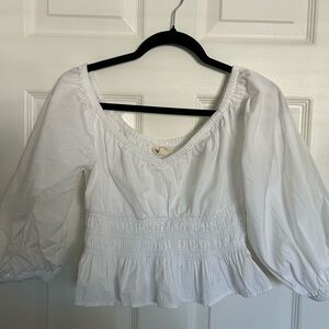 Chic White Blouse with Ruffled Hem